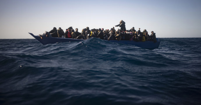 Migrants from Eritrea, Egypt, Syria and Sudan, wait to be assisted by aid workers of the Spanish NGO Open Arms, after fleeing Libya on board a precarious wooden boat in the Mediterranean sea, about 110 miles north of Libya, on Saturday, Jan. 2, 2021. (AP Photo/Joan Mateu)